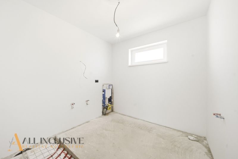 An empty room ready for renovation in a family house with white walls.