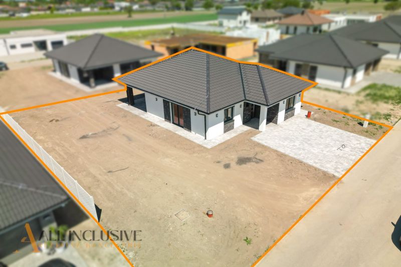 A family house in Hviezdoslavov with a sloped roof and an untended garden.