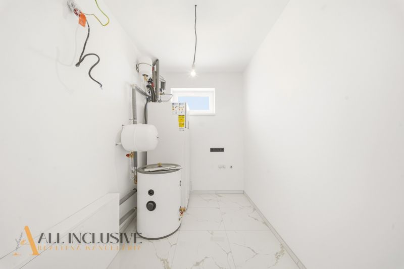 Utility room with white walls and a boiler in a family house.