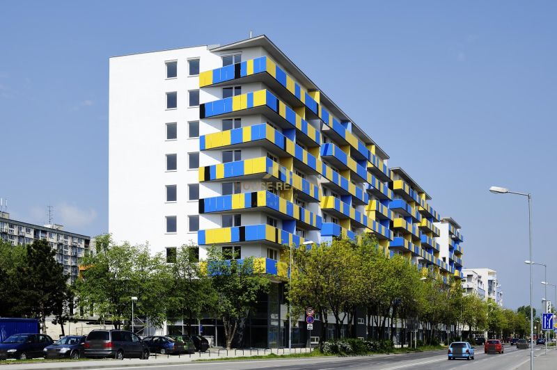 Apartment building on Tomášikova Street, Bratislava - Ružinov, with colorful balconies and parked cars.
