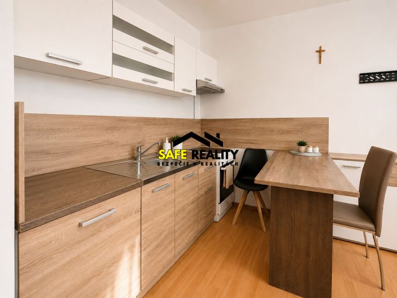 Kitchen unit in a studio apartment with a wooden decor floor and a dining table.