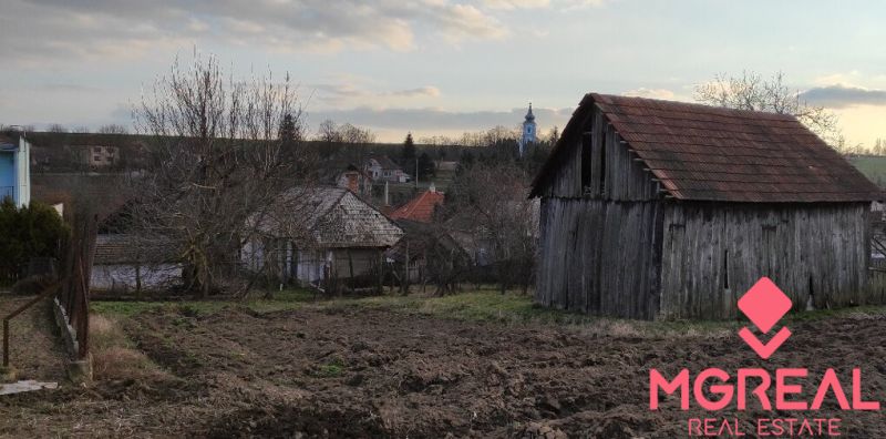 A rural barn and garden in the village of Nové Sady with a panorama of family houses.