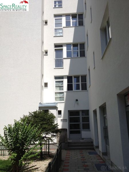 The facade of an apartment building with a garden in Bratislava - Nové Mesto on Vajnorská Street.