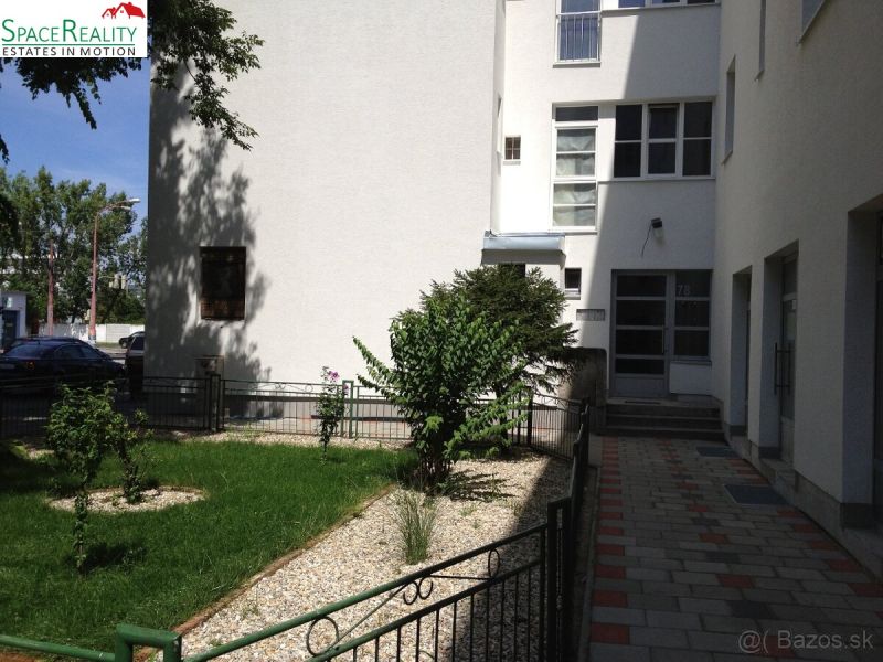 Entrance to the apartment building with a landscaped front garden on Vajnorská Street, Bratislava - Nové Mesto.