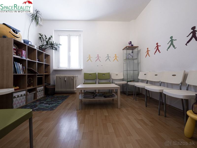Children's room in a 3-room apartment with a wooden decor floor, colorful wall decorations.