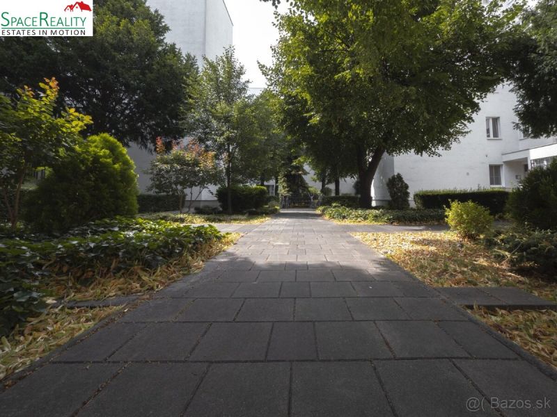 The path leads through a landscaped garden, surrounded by greenery in Bratislava - Nové Mesto on Vajnorská.