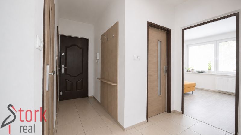 Entrance area of a 3-room apartment with tiles and a built-in wardrobe.