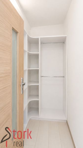 Storage space with shelves and a hanging rod in a 3-room apartment.