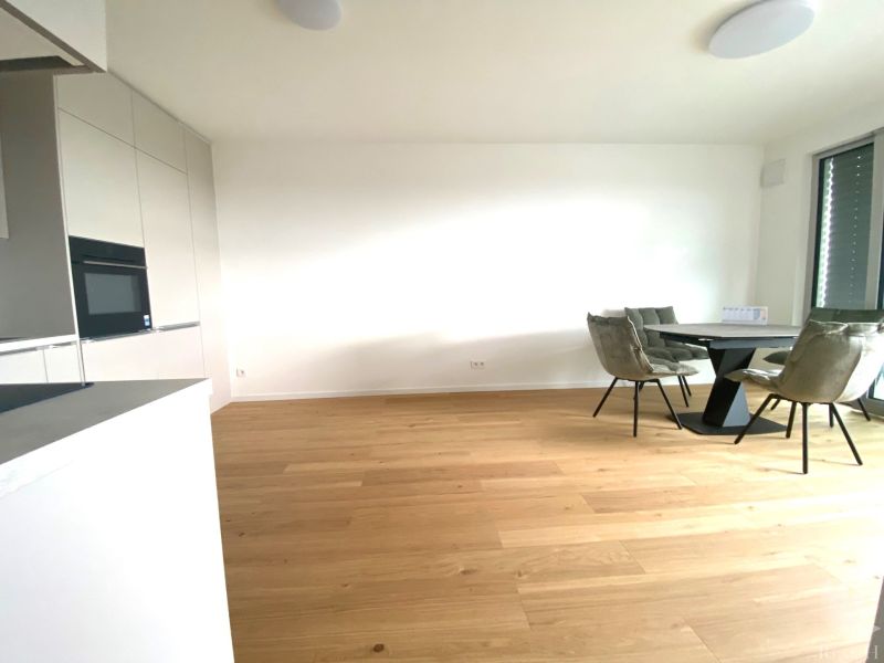 Offices with wood-patterned flooring, white walls, a round table, and four chairs.
