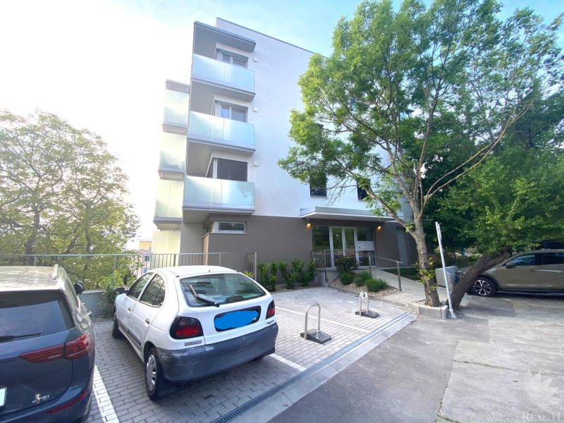 Exterior of the building on Drotárska cesta, Bratislava - Staré Mesto, with a parking lot.