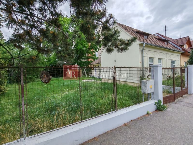 A family house on K Dolnej stanici in Trenčín, enclosed by a fence, with a grassy yard.