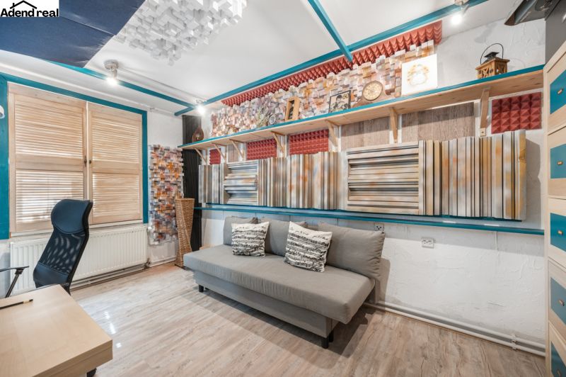 Interior of a family house with a sofa, acoustic panels, and a wooden decor floor.