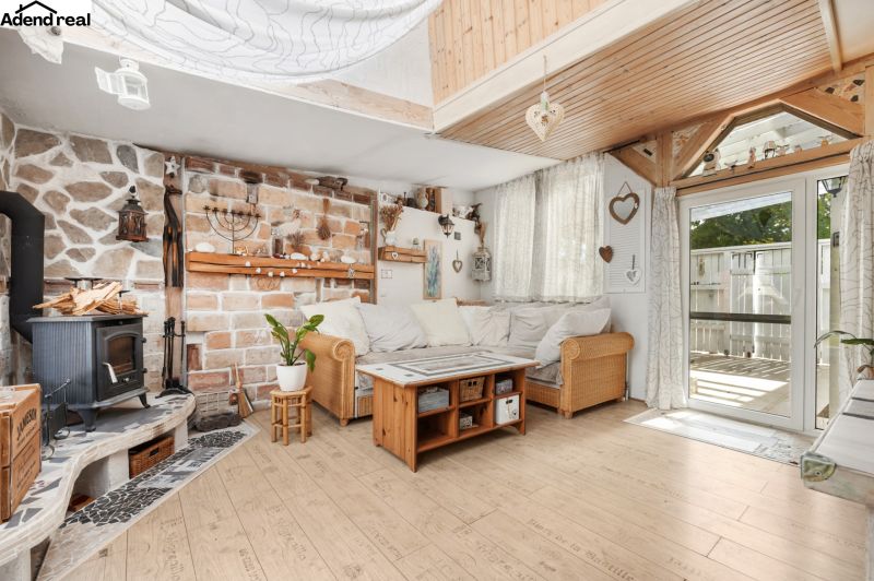 Living room in a family house with a fireplace and a wooden decor floor.