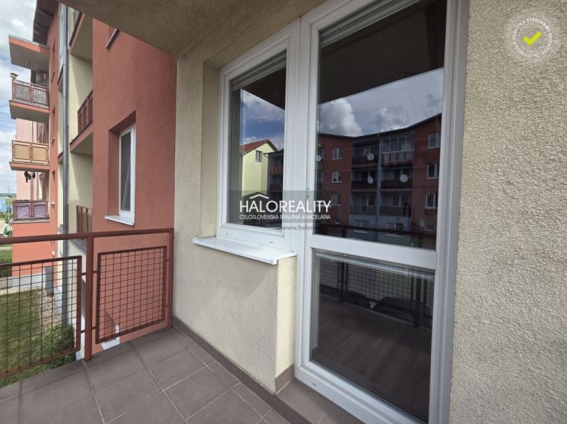 The balcony in the 2-room apartment in Pezinok offers a view of the neighboring buildings.