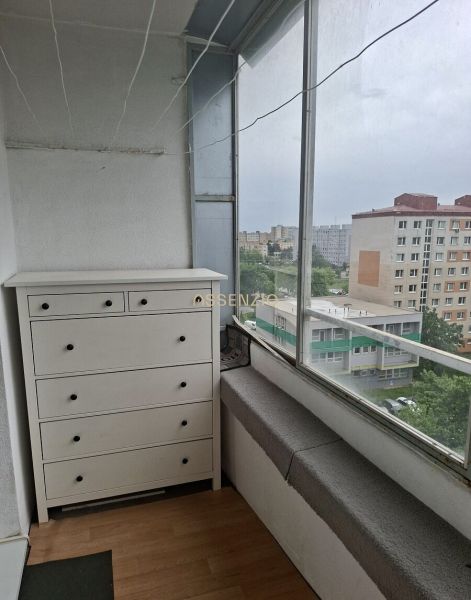 Balcony of a 3-room apartment in Bratislava on Holíčska Street with a wooden decor floor.