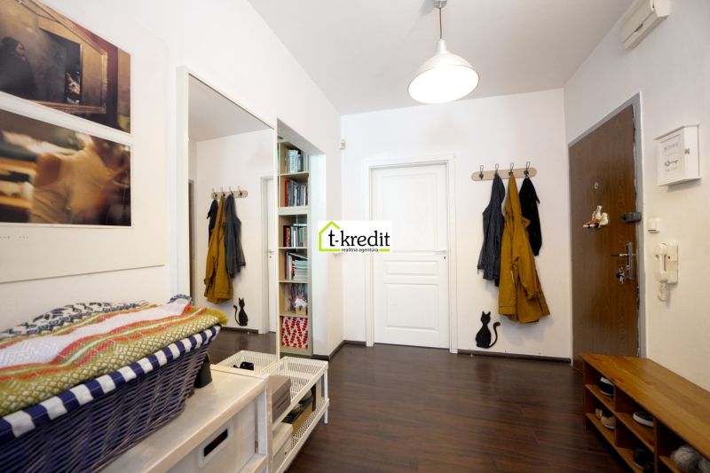 The entrance hall of a 3-room apartment with storage spaces and flooring with a wooden decor.