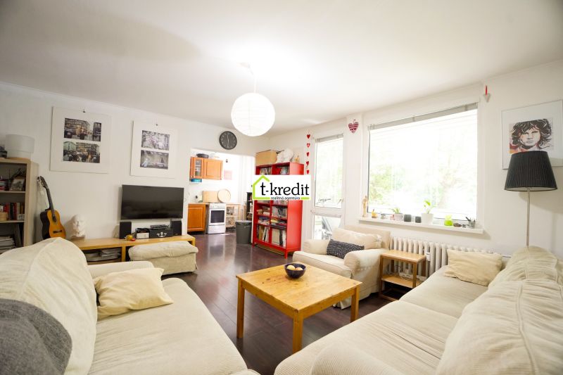 Living room of a 3-room apartment with comfortable sofas and a wooden decor floor.