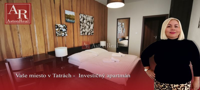 Bedroom with a double bed and wooden paneling in a Holiday Apartment.