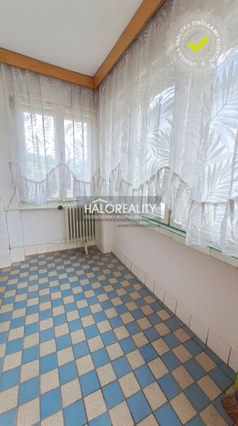 Sunny veranda with checkered tiles and a radiator in a family house.