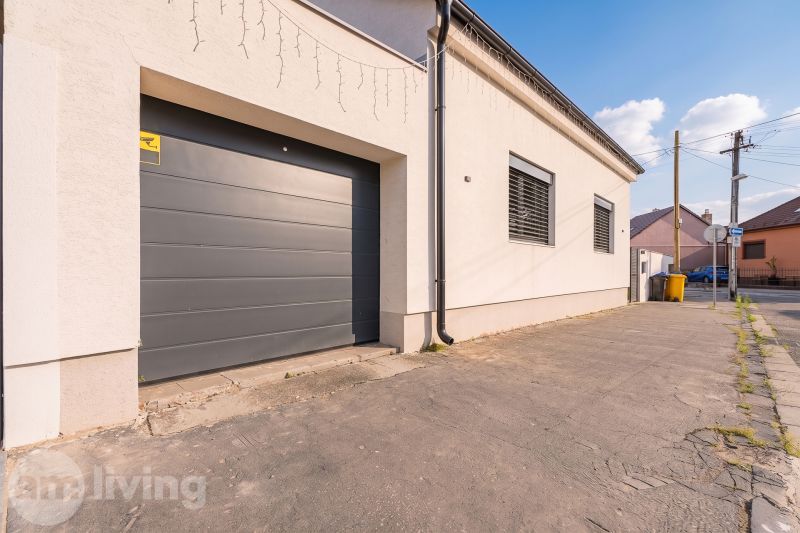 A garage at a family house on Orviský kút in Piešťany with a concrete walkway.