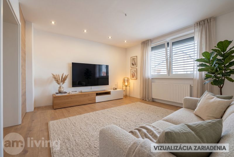 Living room in a family house with a wood-patterned floor and comfortable seating.