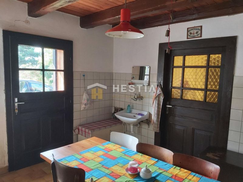 Interior with wood paneling and a colorful tablecloth, bathroom sink. Properties - living.