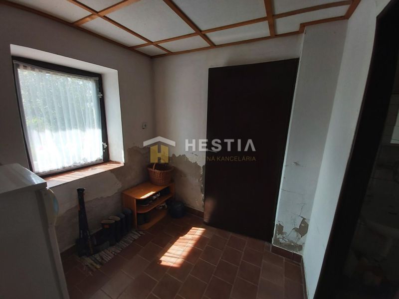 Interior with a window, brick floor, and simple furniture, Land - living.
