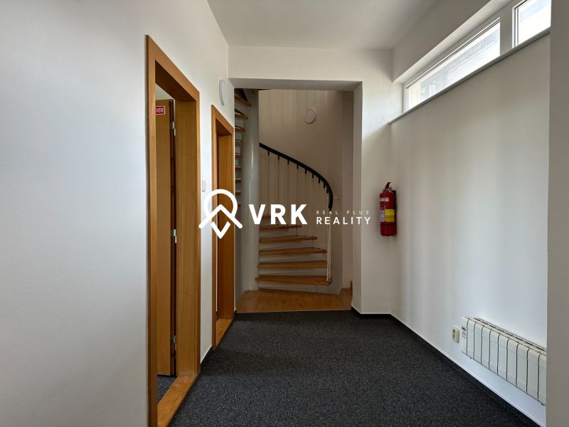 Offices with carpet, staircase, and fire extinguisher.