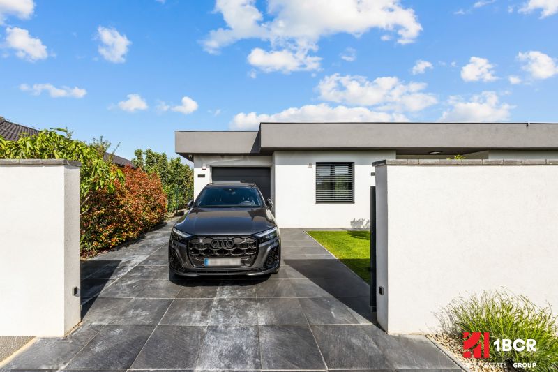 The exterior of a family house on Levanduľová Street in Miloslavov with a black car in the driveway.