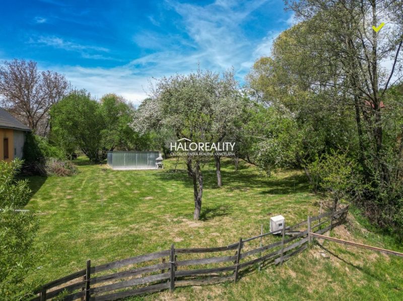 Spacious gardens in Považská Bystrica with fruit trees, a lawn, and a swimming pool.