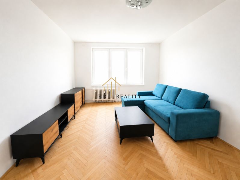 Living room with a sofa, furniture, and flooring with a wood decor in a 2-room apartment.