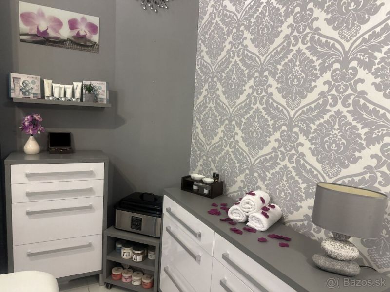 Interior of commercial spaces with white furniture, decorations, and patterned wallpaper.
