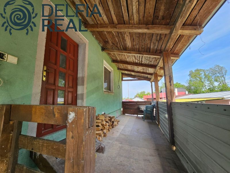 Wooden porch of the cottage on Albaregia Street in Jahodná with wooden railing.