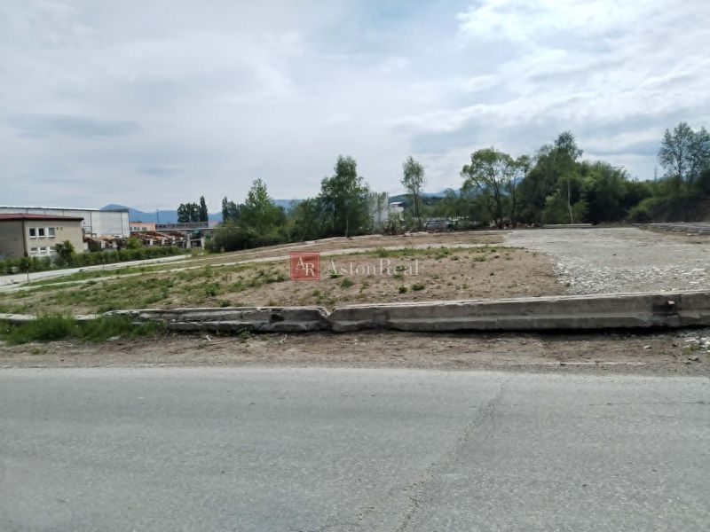 Commercial land in Martin with visible industrial surroundings and an access road.