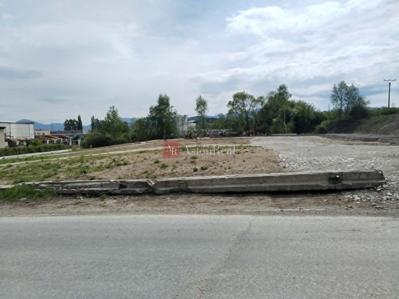 Commercial plots in Martin with an asphalt road and greenery in the background.