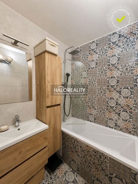 Bathroom in a 2-room apartment with mosaic tiles and modern furniture with a wooden decor.