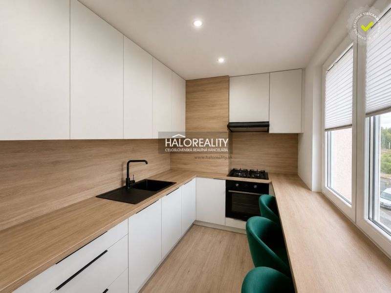 A kitchen in a 2-room apartment with a wooden decor floor and furniture.