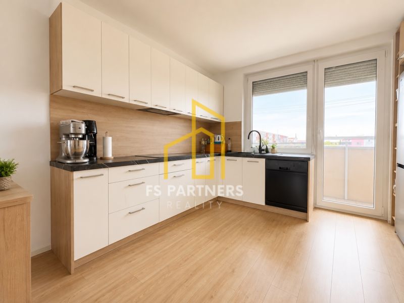 A kitchen in a 3-room apartment with a wooden decor floor and access to a balcony.