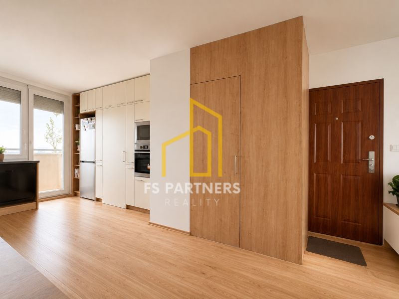 A kitchen in a 3-room apartment with a wooden decor floor and built-in appliances.