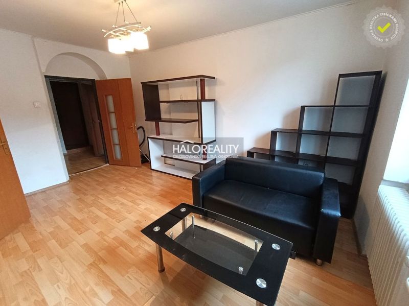 A kitchen in a 3-room apartment with tiles and light furniture.