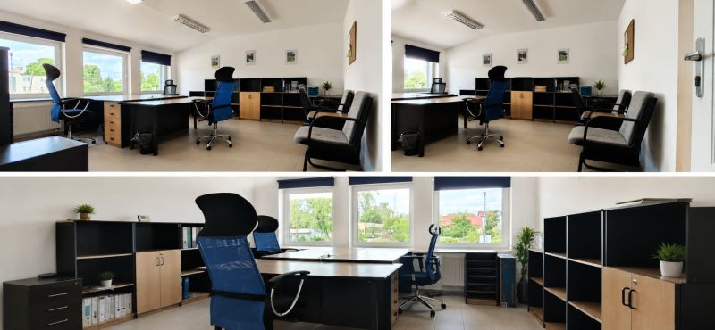 Office space with desks, chairs, and shelves, with large windows and a bright interior.