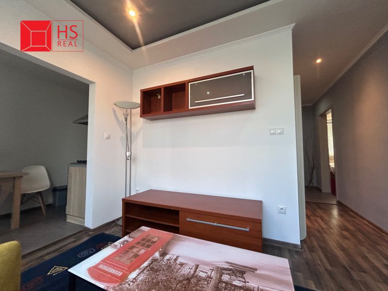Living room in a 3-room apartment with a wooden decor floor and furniture.