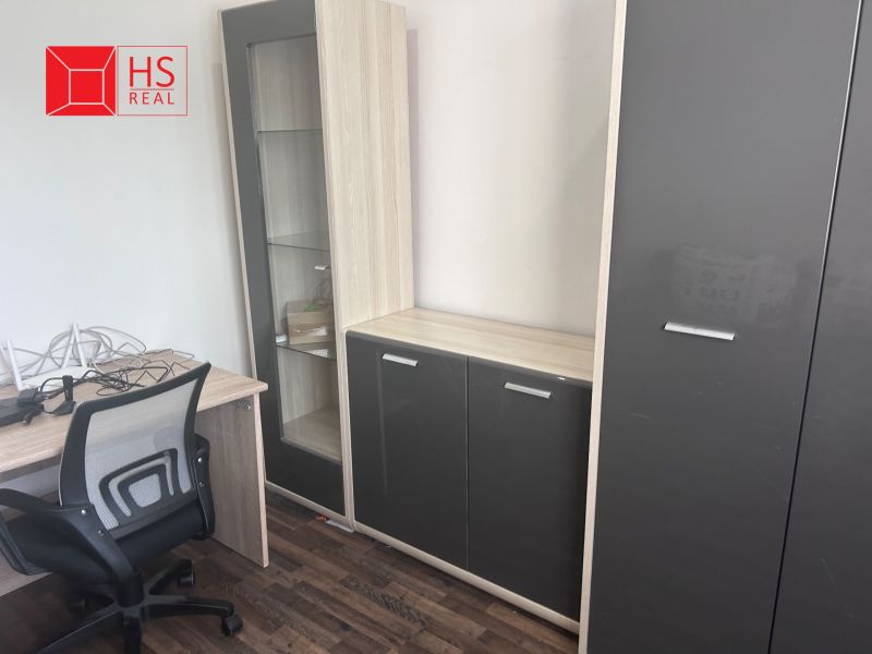 Office furniture with wood-decor flooring in a 3-room apartment.