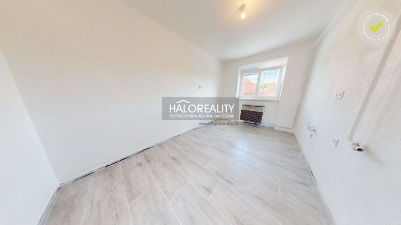 2-room apartment with wood-patterned flooring and white walls.