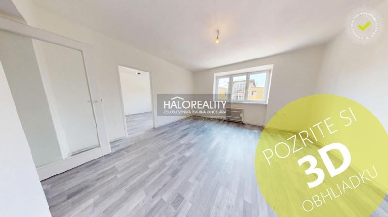 A bright room with a wooden decor floor in a 2-room apartment.