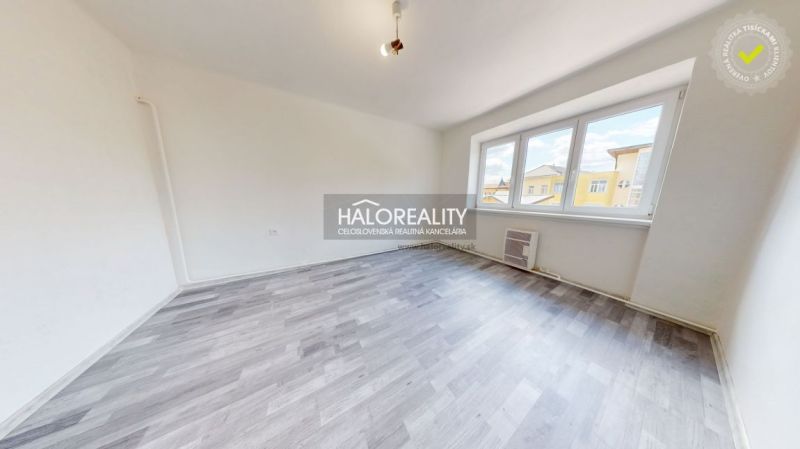 A bright room in a 2-room apartment with a wooden decor floor and large windows.