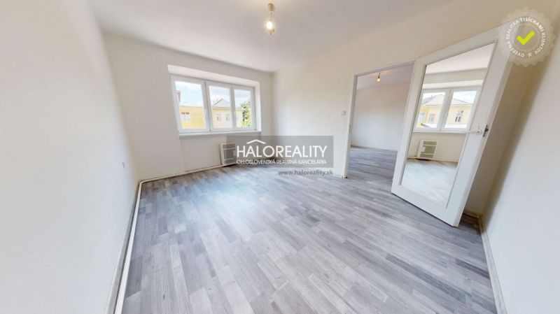 A bright room in a 2-room apartment with a wooden decor floor.