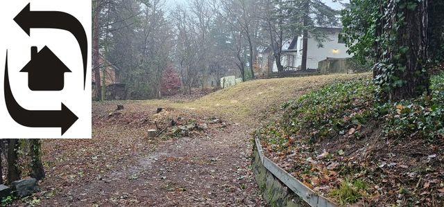A garden on a residential plot in Bratislava - Lamač on Plánky Street, surrounded by trees.