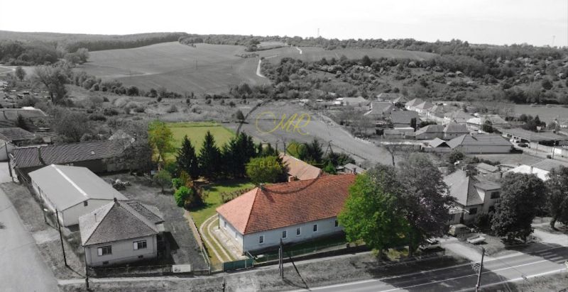 A family house in Čifár surrounded by a garden and the surrounding countryside.