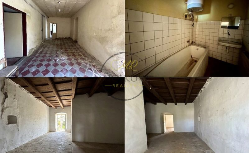 Interior of a family house with a bathtub, tiles, and a wooden ceiling in Čifáre.